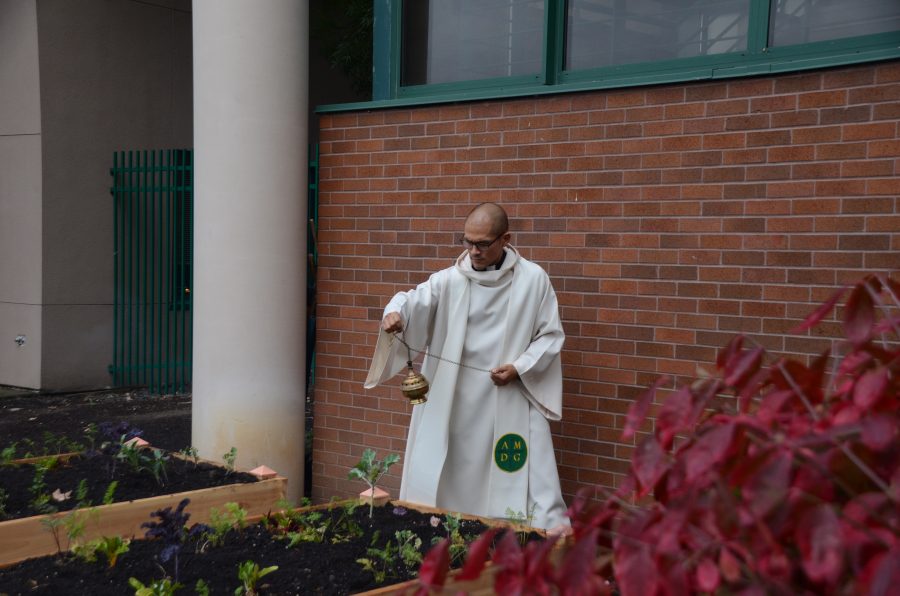 Fr. Claderon spreads incense over the newly built garden