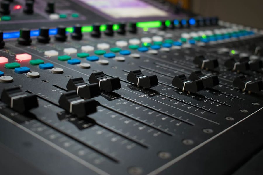 A professional music studio, with a mixing board and professional equipment