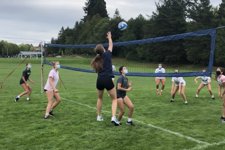 Jesuit women’s volleyball team practicing outside 