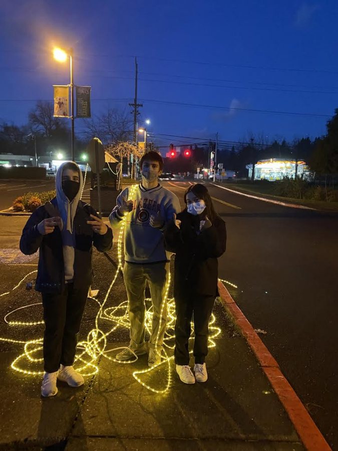 Seniors Anna Dellit, Owen Mackin and Cole Huesby help set up Sader Lights. Photo Curtsey of Gwynne Olson