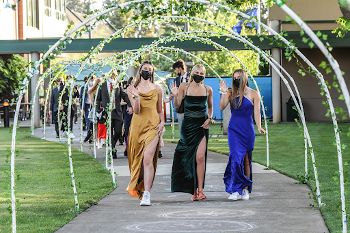 Seniors Eliza Collins, Josie Balish, and Lucy Langer walk down Mary’s Way into Prom on May 15, 2021.