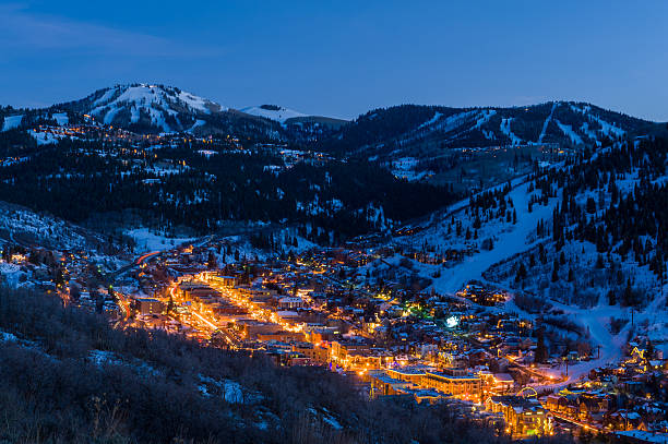 Dusk View of Park City Glowing.  Scenic village from above with cool blue dusk light and glowing warm lights.  Dusk View of Park City Glowing with lights.  Captured as a 14-bit Raw file. Edited in 16-bit ProPhoto RGB color space.