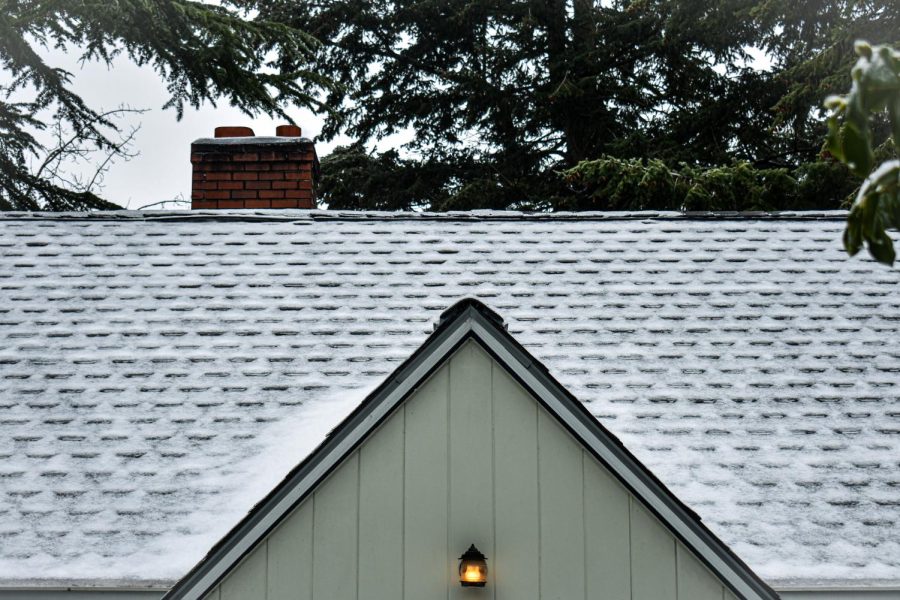 Snow falls atop a roof after the snow storm on April 11.