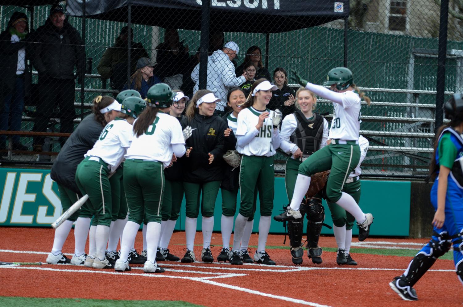 The Crusaders’ softball team celebrates a run. The team sits 14-4 on the season.