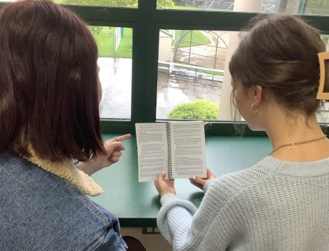 Students reviewing the dress code section of the Jesuit Student Handbook