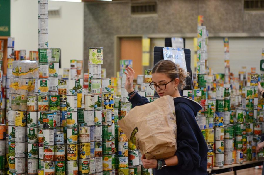 Students sort collected cans for the food drive.