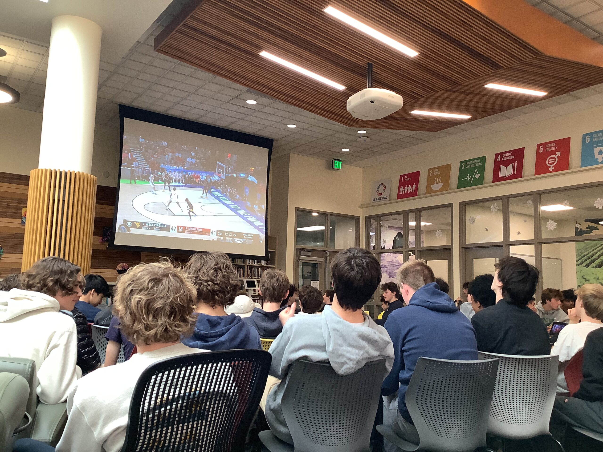 Students watch the Men’s March Madness tournament during break.