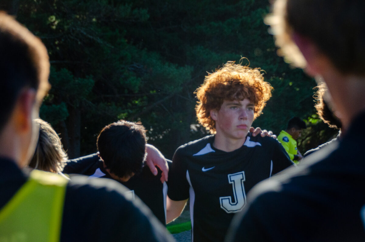 JV mens soccer huddles during a game early in the season.