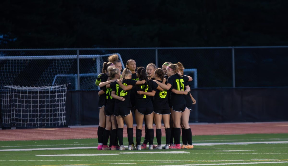 Team huddle on Cronin field before kickoff before the game versus Lake Oswego.