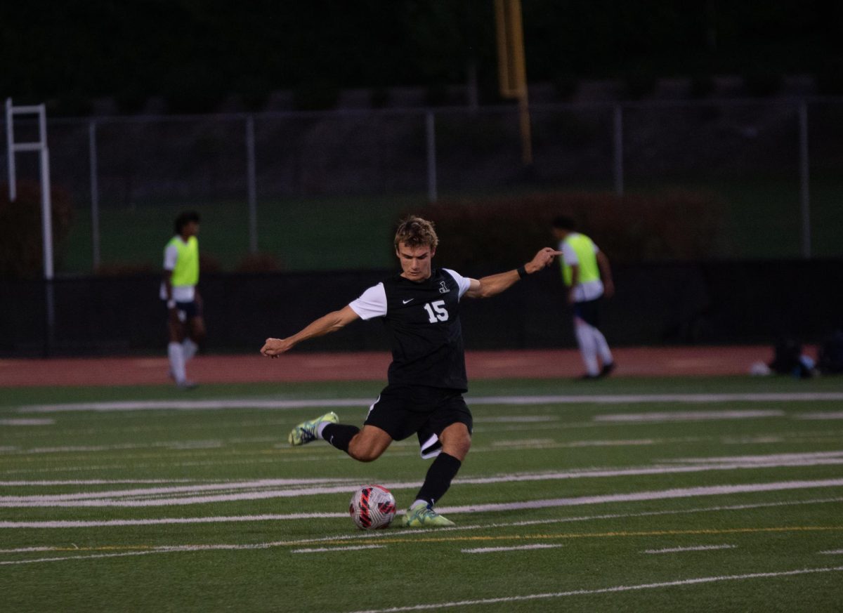 Nathan Peters taking a free kick after getting fouled by Grant High School.