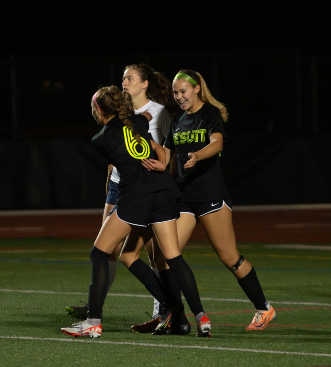 Jo Frischknecht celebrating with Ana Kubiaczyk and Claudia Rose after her goal in the game against Westview.
