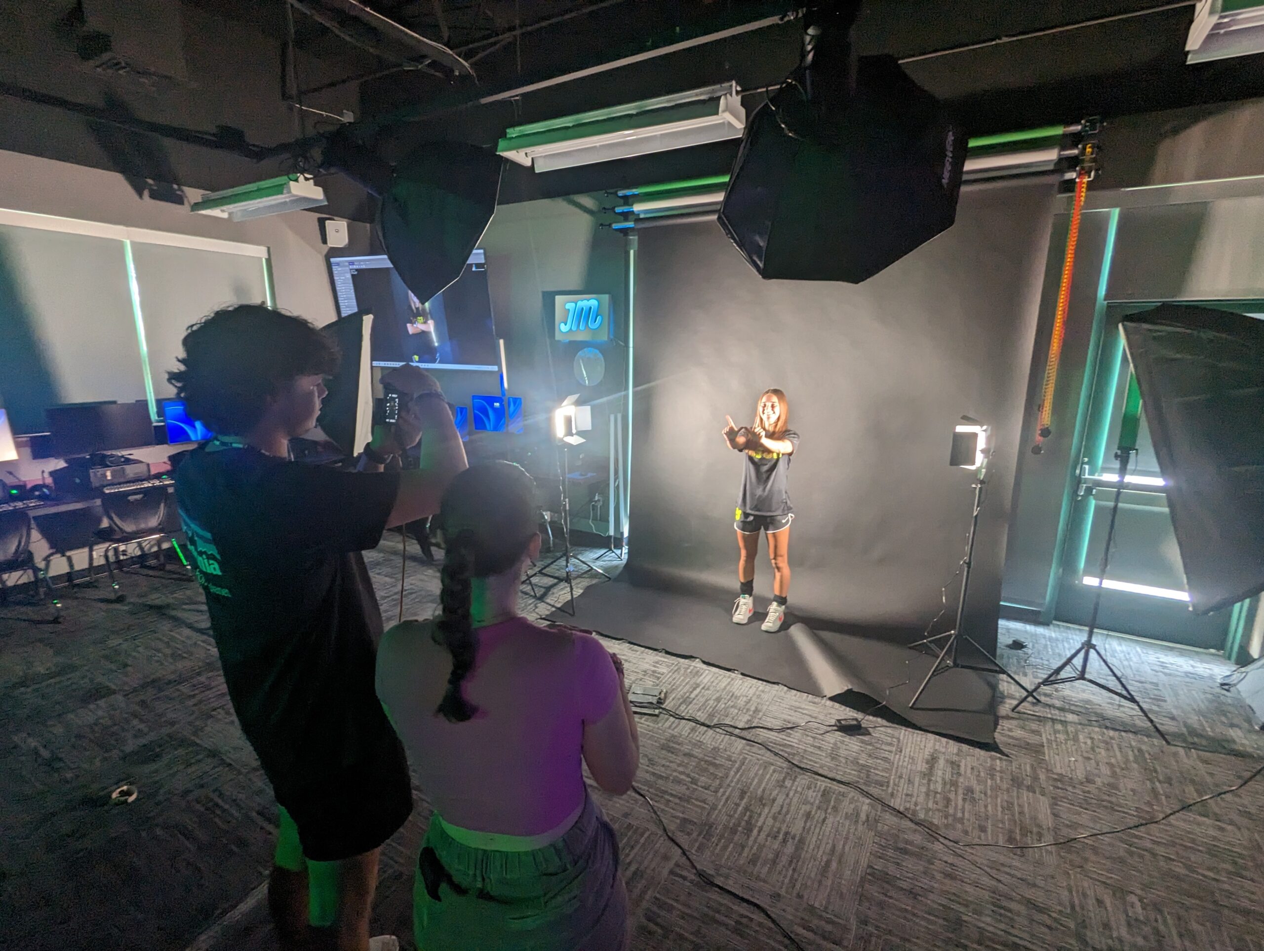 Seniors Hudson Rommel and Soleil Scott use the photo studio during the womens soccer media day shoot.