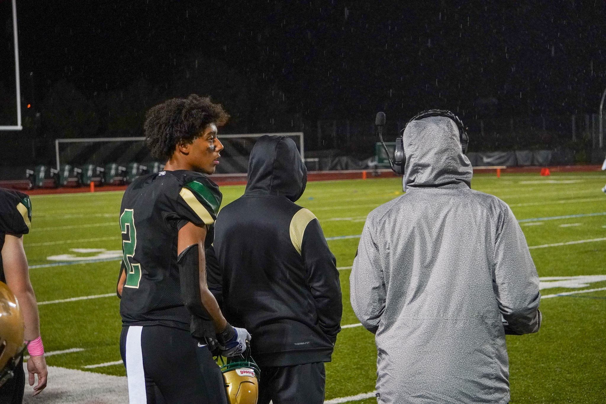 #2 Elias Johnson speaks with his coach on the sideline before entering the game.