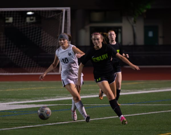 Junior Kaitlyn MacLennan rushes up the pitch against Lake Oswego in a regular season matchup.