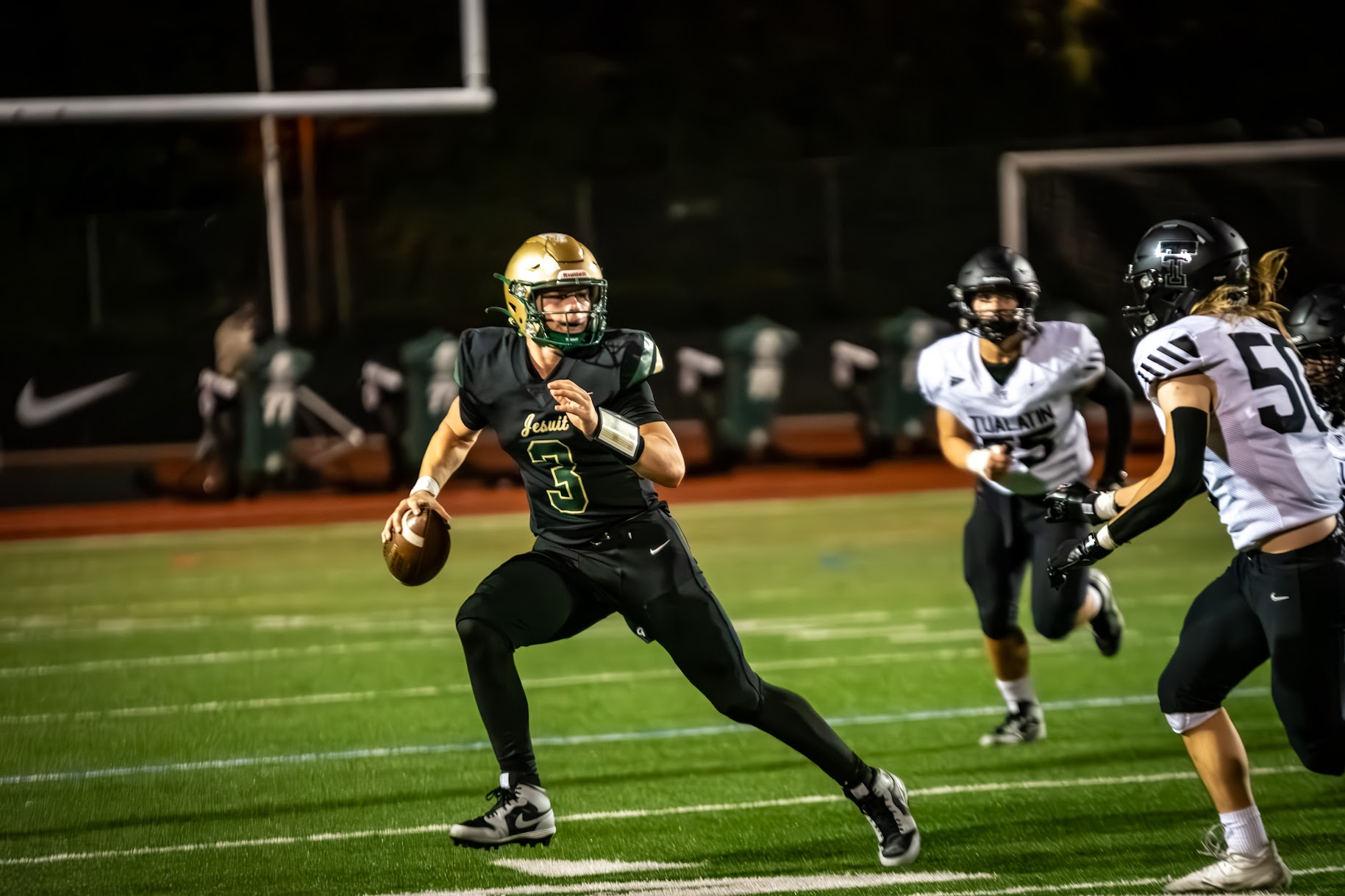#3 Trey Cleeland evades the rush in an early season game against Tualatin. Cleeland will face #1 ranked West Linn in the OSAA second round of football playoffs.