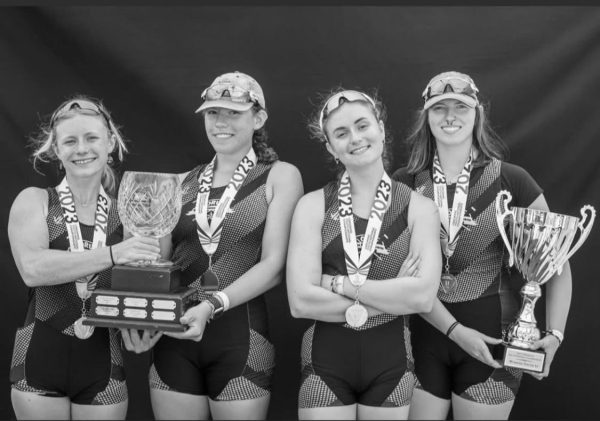 Claire Sopko (second from left) holds a 2023 national trophy with her quad.