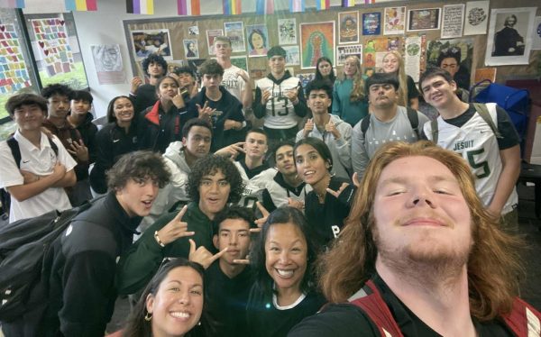 Students from Pacific-Islander Club gather in the DEI office for a selfie.