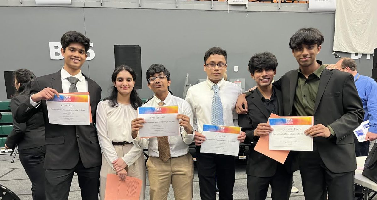 D’Costa and Malpani holding their ISEF certificate on the right