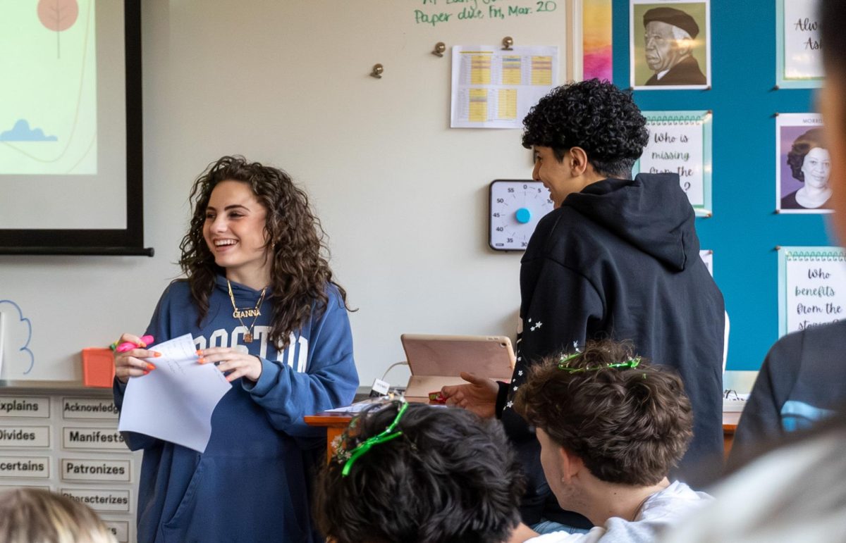 Pavley Kamel makes his case to Gianna Ayoub, arguing why his group deserves to win the candy reward in the Immigration Scenarios activity.